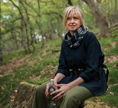 Paula Hickey Photograph of a woman sitting in a woodland